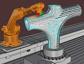 In einer 3D-Grafik ist ein orange gefärbter Robterarm zu erkennen, an dessen vorderem Teil sich ein Magnet mit grün gefärbter positiver und rot gefärbter negativer Seite befindet. Der Magnet setzt an einem T-förmigen Werkstück an.