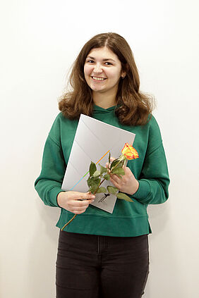 Es ist die ukrainische Studentin mit ihrer Urkunde und einer Blumen in der Hand zu sehen.